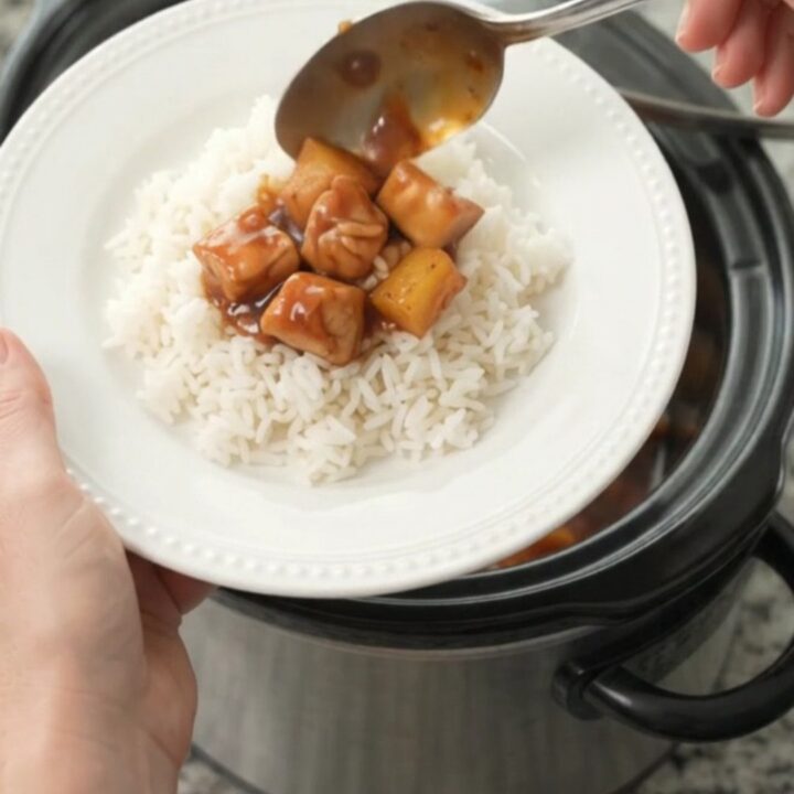 Slow cooker filled with glazed chicken and pineapple chunks in hickory BBQ sauce