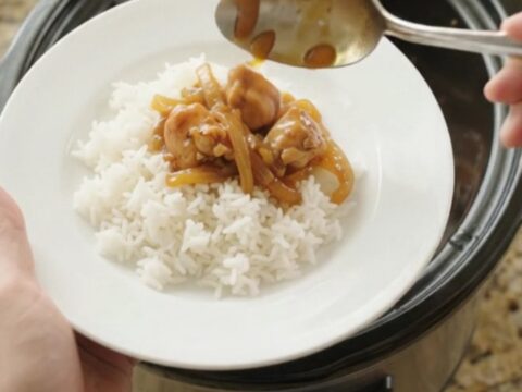 Glazed apricot hickory BBQ chicken bites in a slow cooker, glossy and steaming