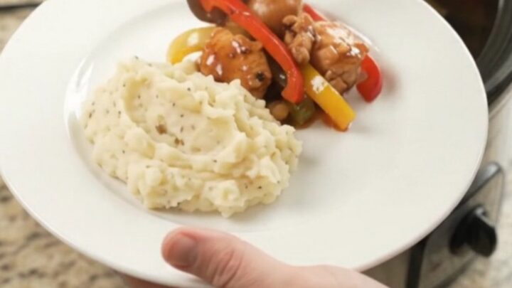Slow cooker bourbon glazed chicken bites with bell peppers in a glossy sauce