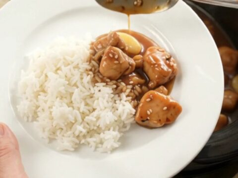 Slow cooker teriyaki chicken bites with garlic and scallions, glazed and glossy in the pot