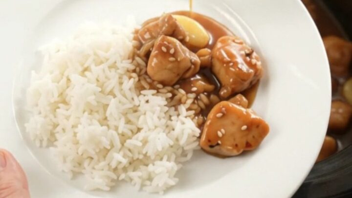 Slow cooker teriyaki chicken bites with garlic and scallions, glazed and glossy in the pot