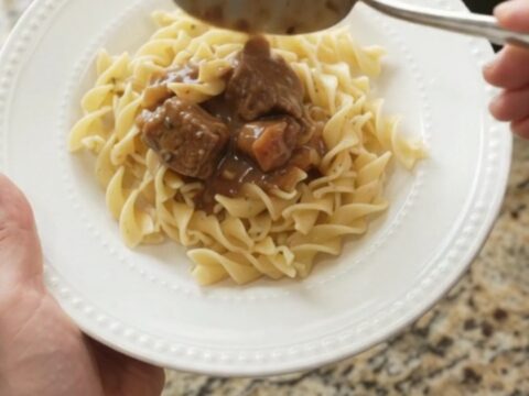 Slow cooker beef stroganoff with carrots and potatoes in a creamy gravy