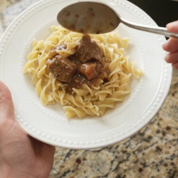 Slow cooker beef stroganoff with carrots and potatoes in a creamy gravy