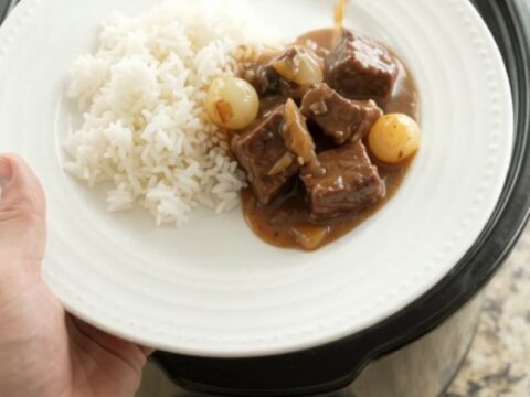 Slow cooker beef with pearl onions and carrots in bourbon gravy