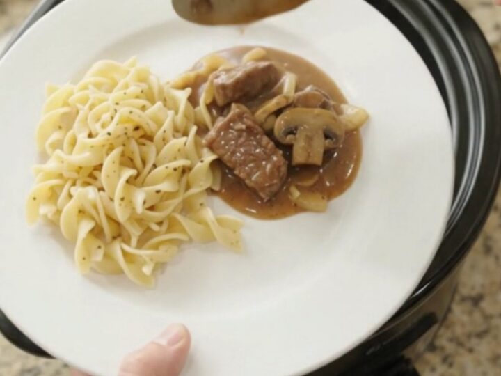 Slow cooker sirloin tips in a creamy mushroom gravy, served over buttered egg noodles.