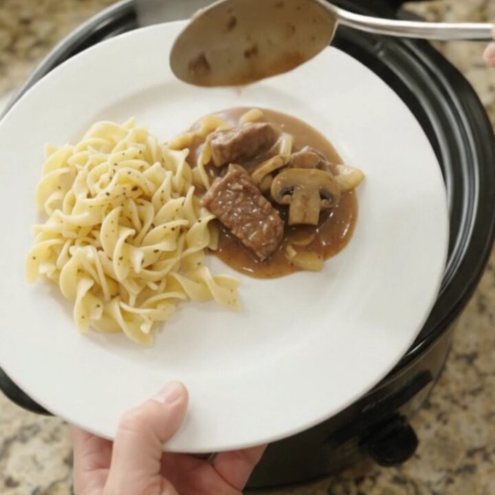 Slow cooker sirloin tips in a creamy mushroom gravy, served over buttered egg noodles.