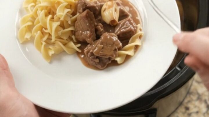 Slow cooker filled with sirloin tips and baby potatoes in a creamy brown gravy