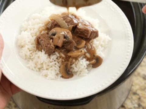 Slow cooker sirloin tips in rich bourbon mushroom gravy, topped with mushrooms and onions