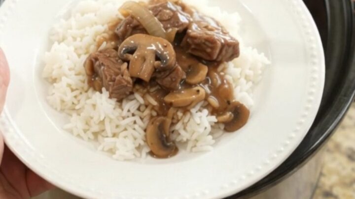 Slow cooker sirloin tips in rich bourbon mushroom gravy, topped with mushrooms and onions