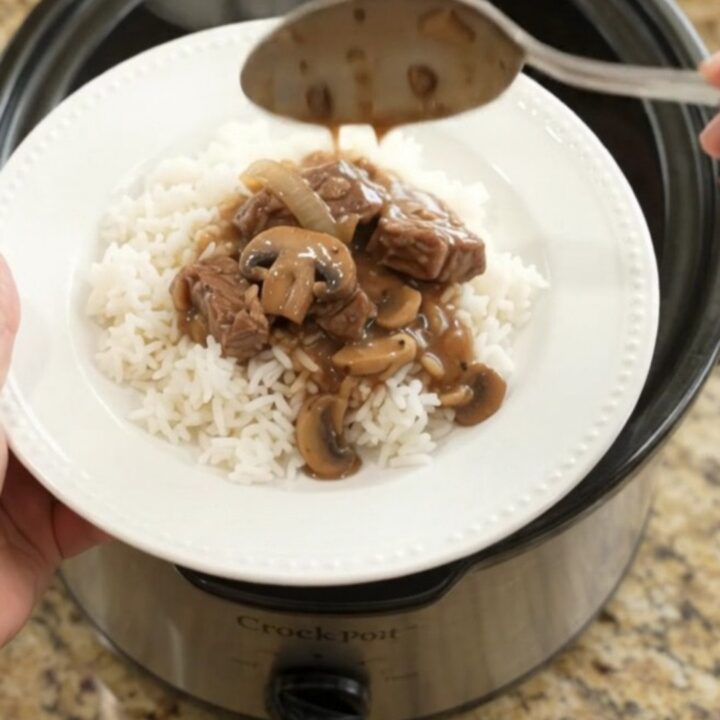 Slow cooker sirloin tips in rich bourbon mushroom gravy, topped with mushrooms and onions