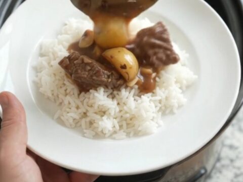 Slow-cooker sirloin tips and potatoes in bourbon gravy in a black crockpot