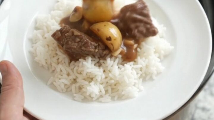 Slow-cooker sirloin tips and potatoes in bourbon gravy in a black crockpot