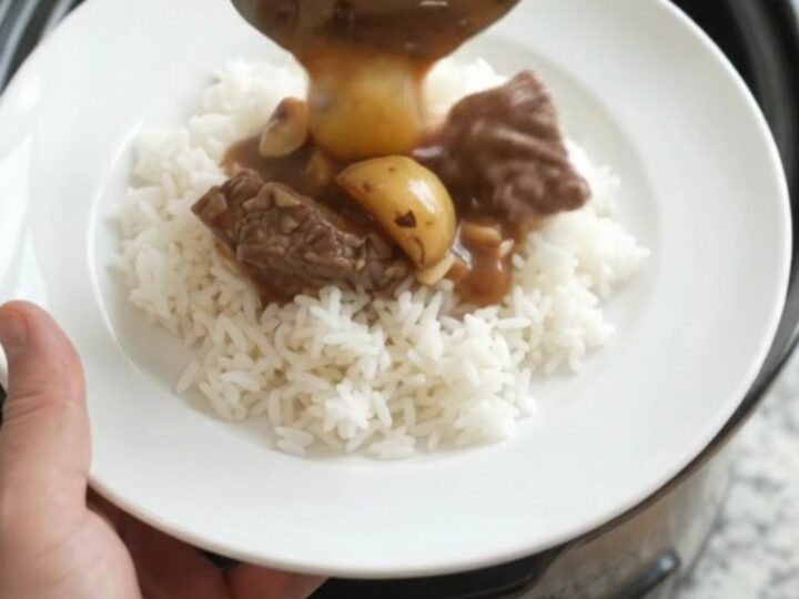 Slow-cooker sirloin tips and potatoes in bourbon gravy in a black crockpot