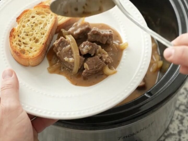 Slow cooker filled with tender sirloin tips and onions in a creamy Gruyère sauce