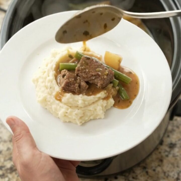 Slow cooker sirloin tips with green beans and potatoes in a rich garlic-herb butter sauce