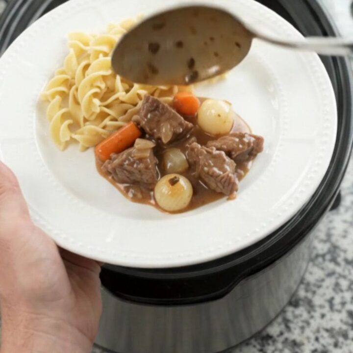 Tender sirloin tips in creamy sour cream gravy with pearl onions and carrots in a slow cooker