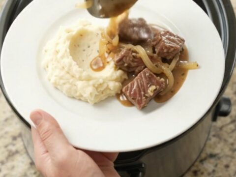 Slow cooker ribeye bites with caramelized onions in a rich buttery au jus.