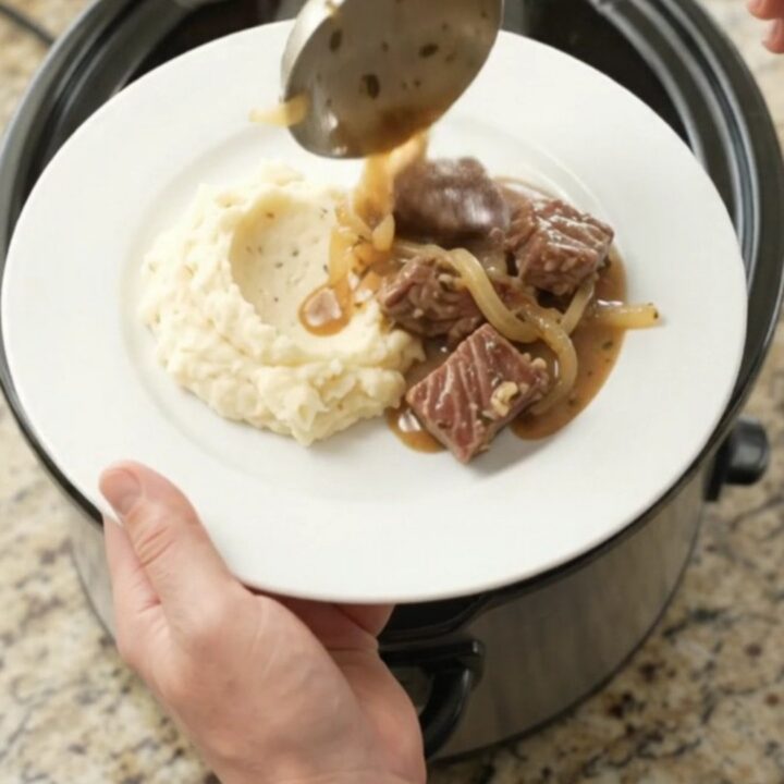 Slow cooker ribeye bites with caramelized onions in a rich buttery au jus.