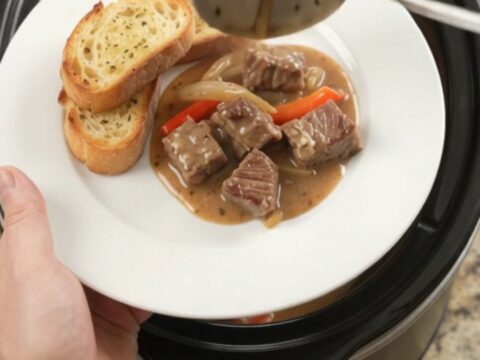 Slow cooker ribeye bites with peppers and onions in creamy Gruyère sauce
