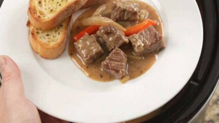 Slow cooker ribeye bites with peppers and onions in creamy Gruyère sauce