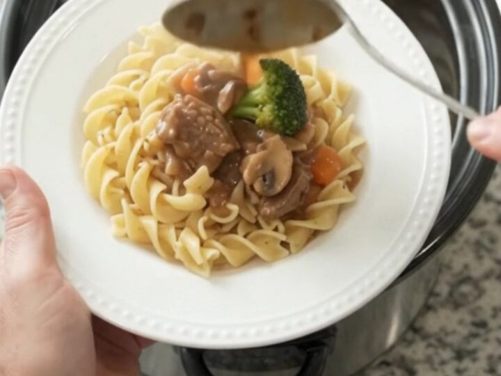 Slow cooker sour cream broccoli ribeye bites with gravy in a black crockpot
