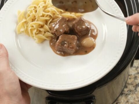 Slow cooker ribeye bites and portobello mushrooms in sour cream gravy, served over buttered egg noodles