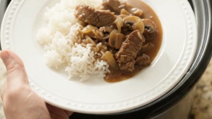 Tender flank steak strips in bourbon-mushroom gravy with mushrooms and onions in a slow cooker