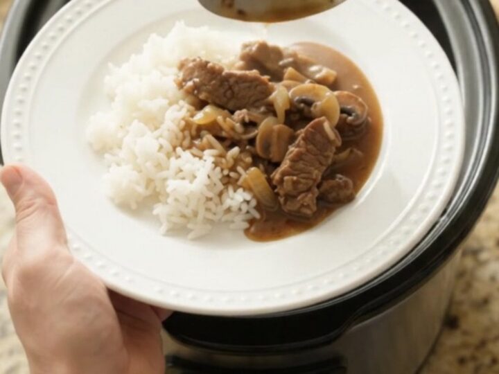 Tender flank steak strips in bourbon-mushroom gravy with mushrooms and onions in a slow cooker