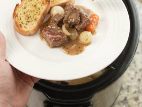 Crockpot ribeye bites with pearl onions and carrots in creamy Gruyère sauce