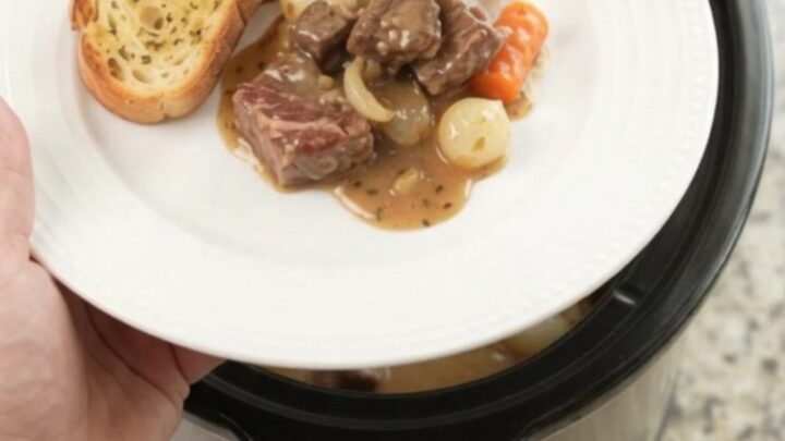 Crockpot ribeye bites with pearl onions and carrots in creamy Gruyère sauce
