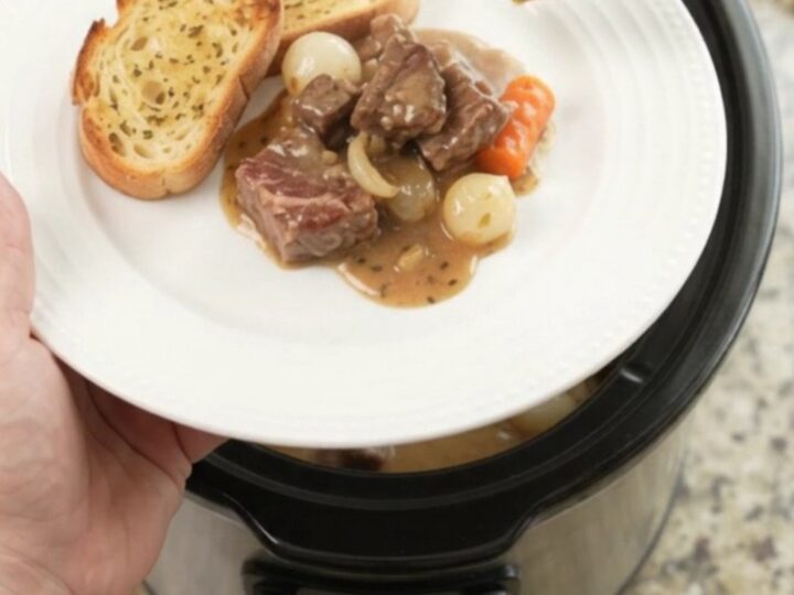 Crockpot ribeye bites with pearl onions and carrots in creamy Gruyère sauce