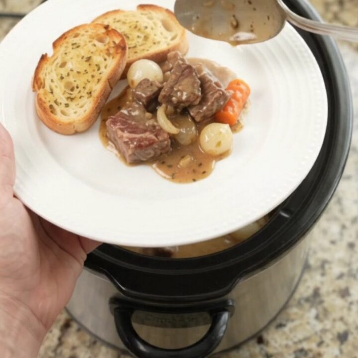 Crockpot ribeye bites with pearl onions and carrots in creamy Gruyère sauce