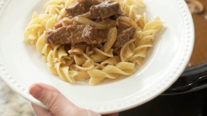 Slow cooker flank steak in creamy mushroom gravy with onions