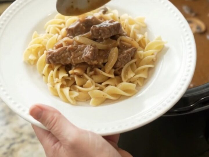Slow cooker flank steak in creamy mushroom gravy with onions