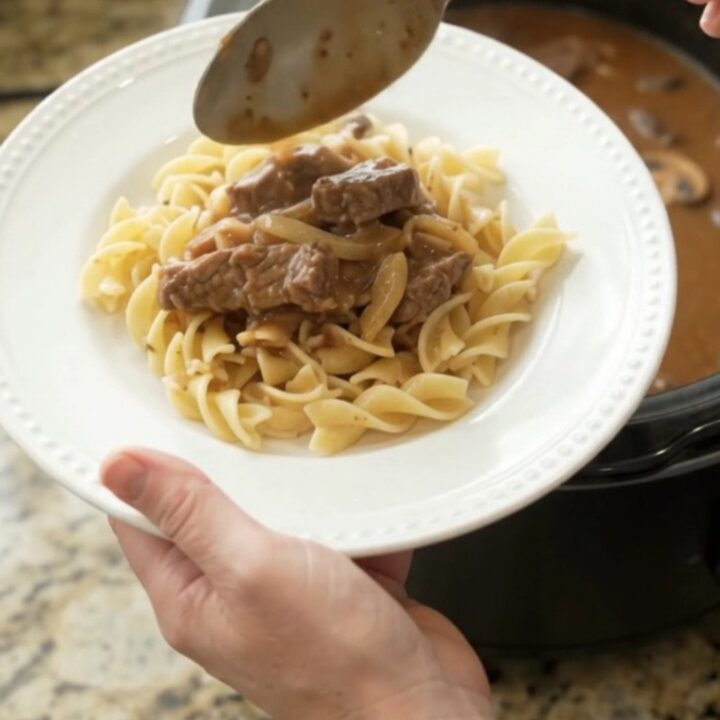Slow cooker flank steak in creamy mushroom gravy with onions