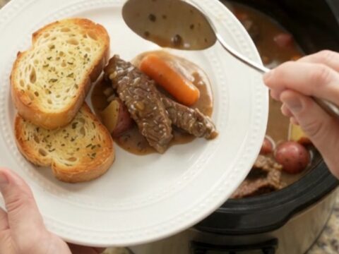 Slow cooker flank steak with carrots and potatoes in a creamy Gruyère sauce
