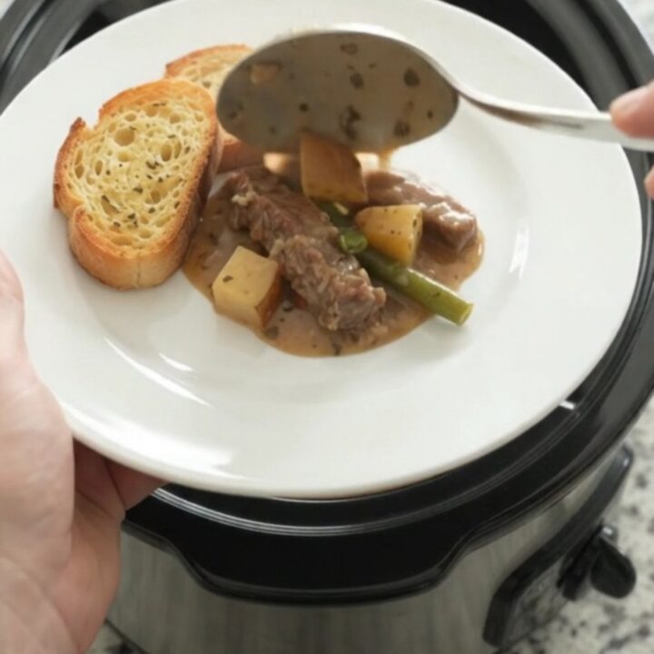 Slow cooker flank steak with green beans and potatoes in creamy Gruyère sauce