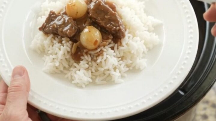 Slow cooker flank steak with pearl onions and carrots in bourbon gravy