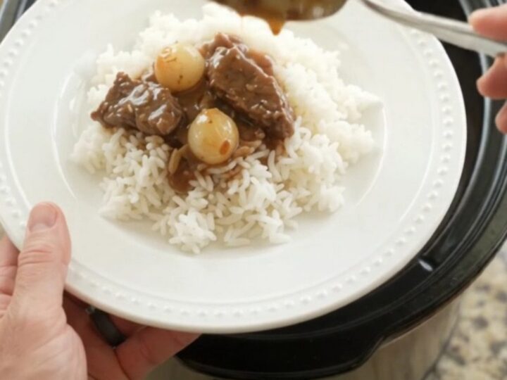 Slow cooker flank steak with pearl onions and carrots in bourbon gravy