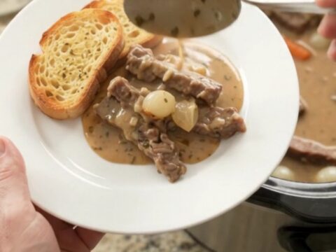 Creamy Gruyère flank steak slow cooker dinner with pearl onions and carrots in a rich sauce