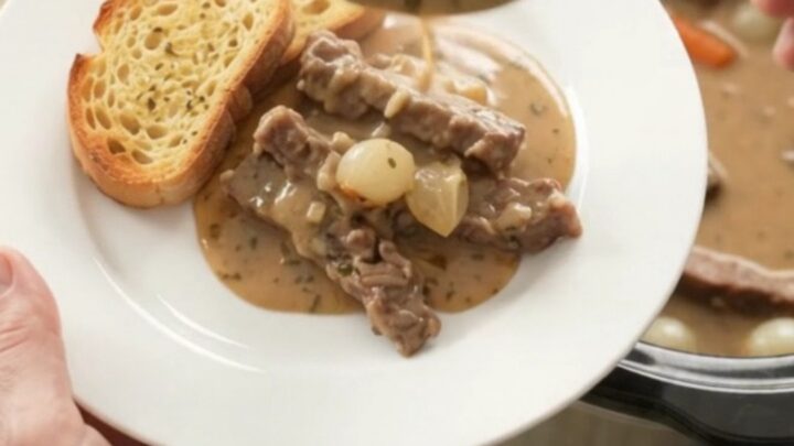 Creamy Gruyère flank steak slow cooker dinner with pearl onions and carrots in a rich sauce