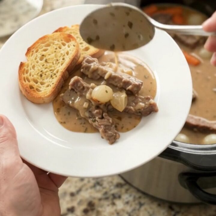 Creamy Gruyère flank steak slow cooker dinner with pearl onions and carrots in a rich sauce