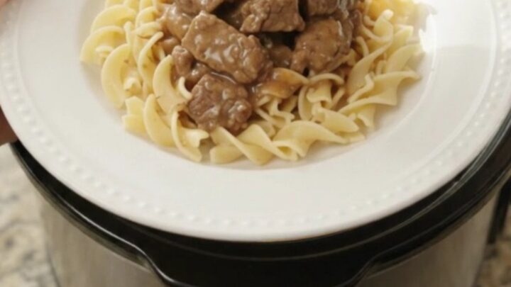 Slow cooker beef tenderloin tips with potatoes in a creamy gravy, served in the crock