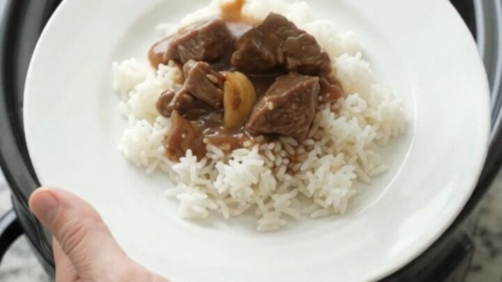 Slow cooker beef tenderloin tips with potatoes and gravy in a black crockpot