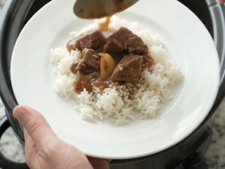 Slow cooker beef tenderloin tips with potatoes and gravy in a black crockpot