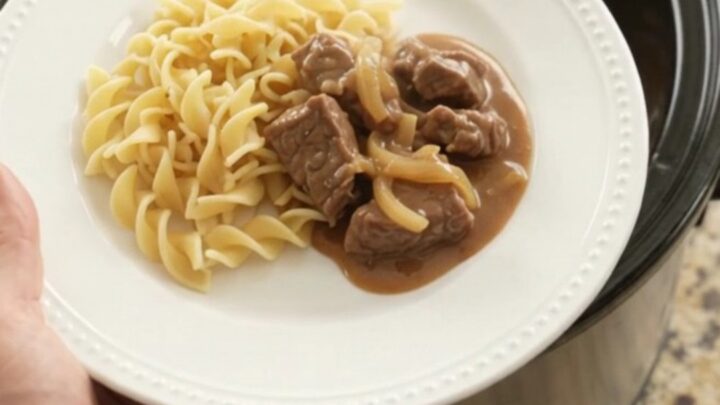 Sour cream French onion tenderloin tips in a slow cooker, topped with gravy