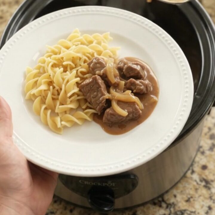 Sour cream French onion tenderloin tips in a slow cooker, topped with gravy