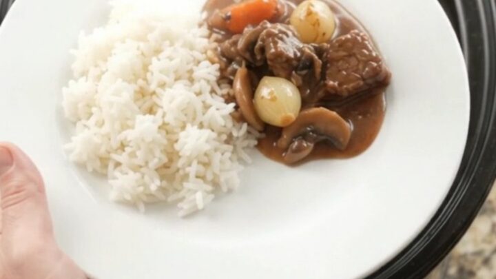 Slow cooker beef tenderloin tips with pearl onions and carrots in bourbon gravy