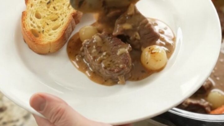 Slow-cooked beef tenderloin tips in creamy Gruyère sauce with pearl onions and carrots, served in a Crockpot