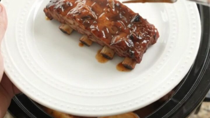 Slow cooker ribs with apples and BBQ sauce, glistening and tender